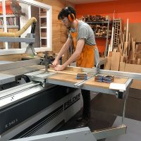 A student at Heartwood Creative uses a Felder panel saw.